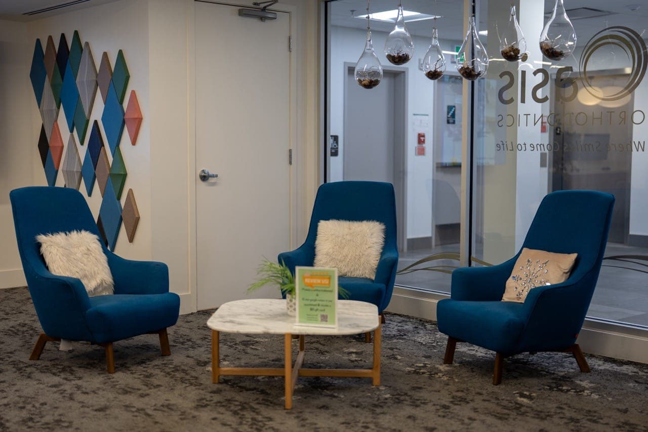 Waiting area with blue armchairs and a coffee table