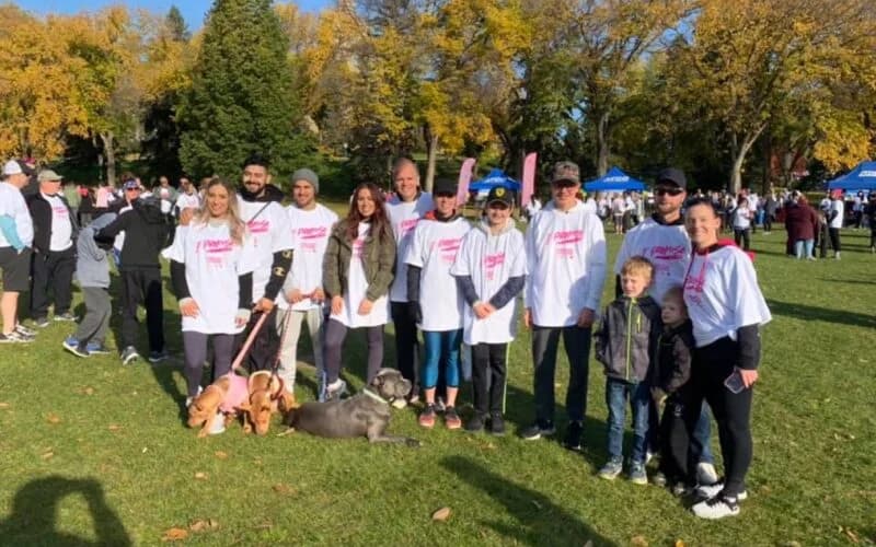 Oasis Orthodontics team and families together at a charity walk in a park