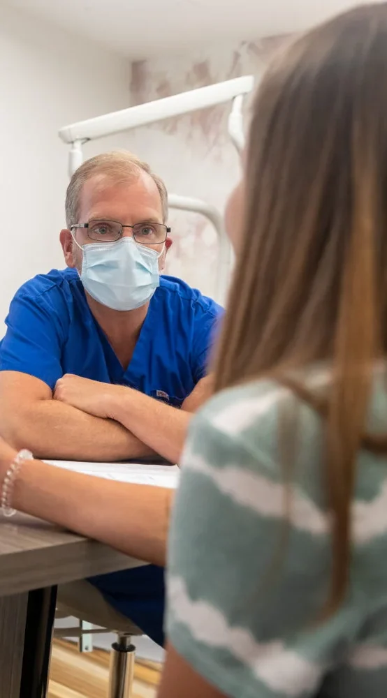 Orthodontist discussing treatment options with a patient during a consultation