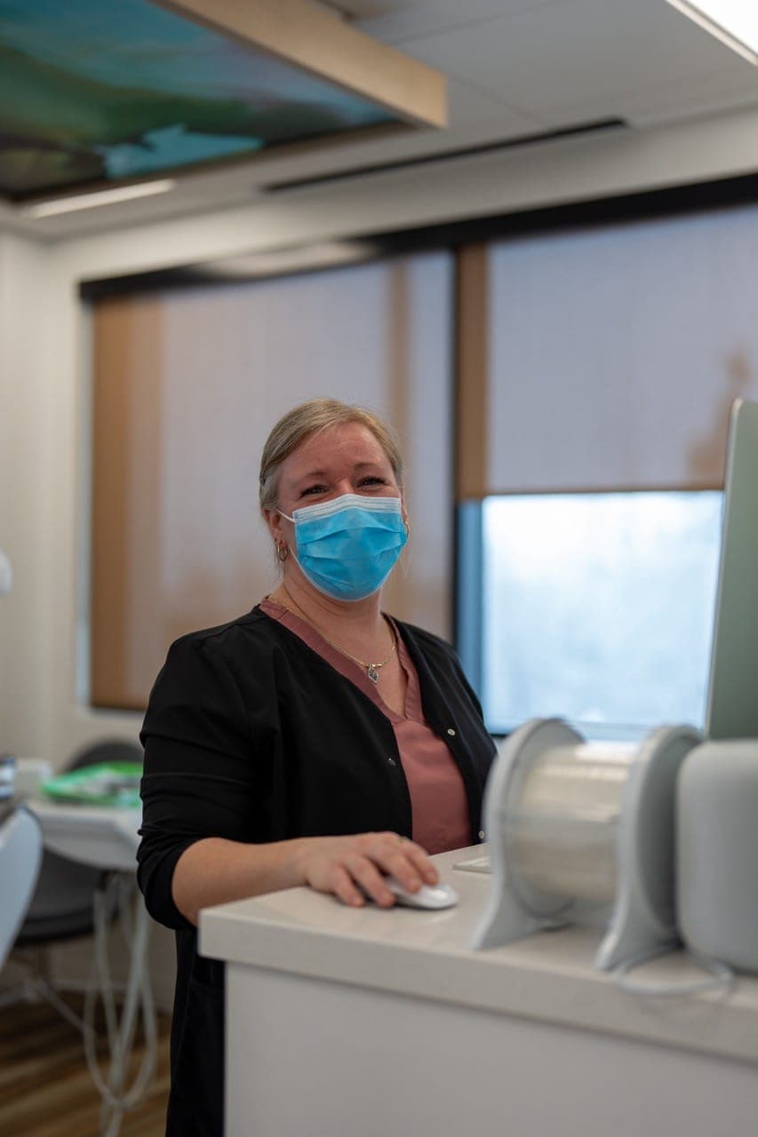 Team member in a mask standing at the clinic counter