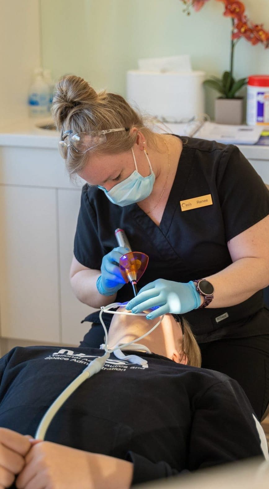 Orthodontic assistant treating a patient in the chair