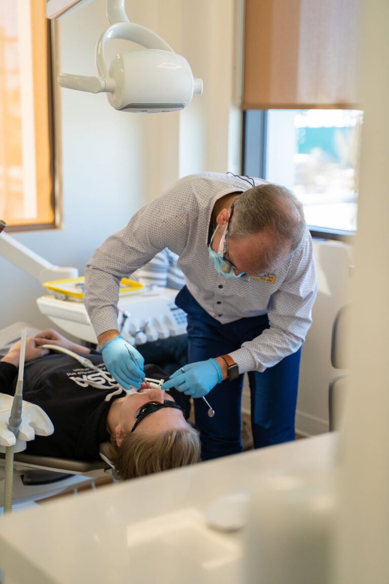 Dr Knoefel fixing braces to a patient