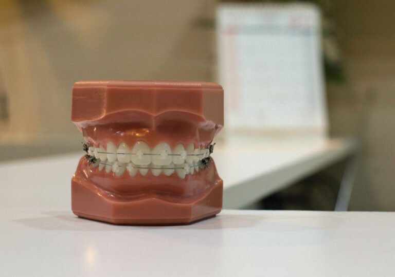 Close up shot of false teeth showing braces attached